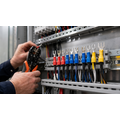 Insulated forked spade terminals in red, blue and yellow installed on switchboard wiring terminals by an Australian electrician